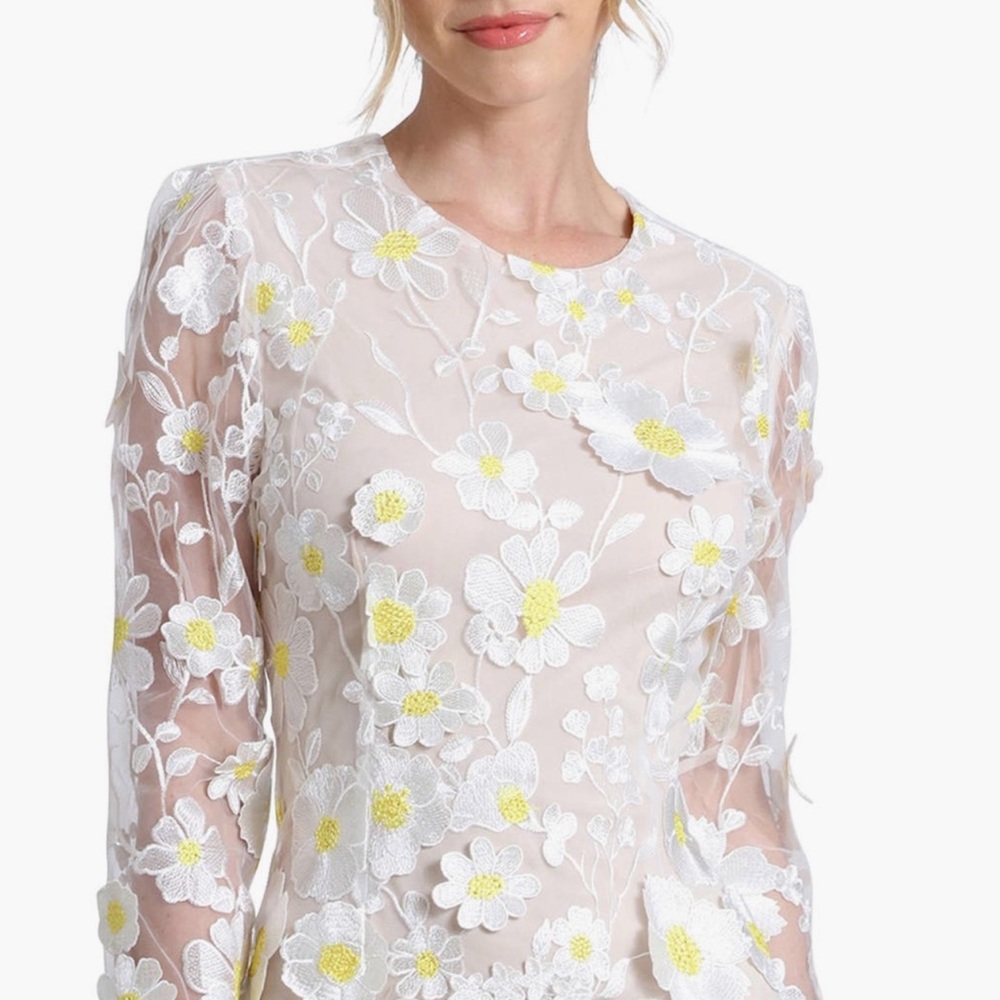 Beautiful embroidered flowers shower a celebration minidress.